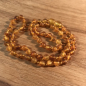 Preview: Bernsteinkette kurz, kleine Perlen, mattiert-honighell, ca. 45 cm